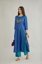Teal blue hand crushed silk straight kurta set with vertical organza fabric inset stripe detail in front, back and 3/4 sleeves, highlighted with contrasting top stitch.