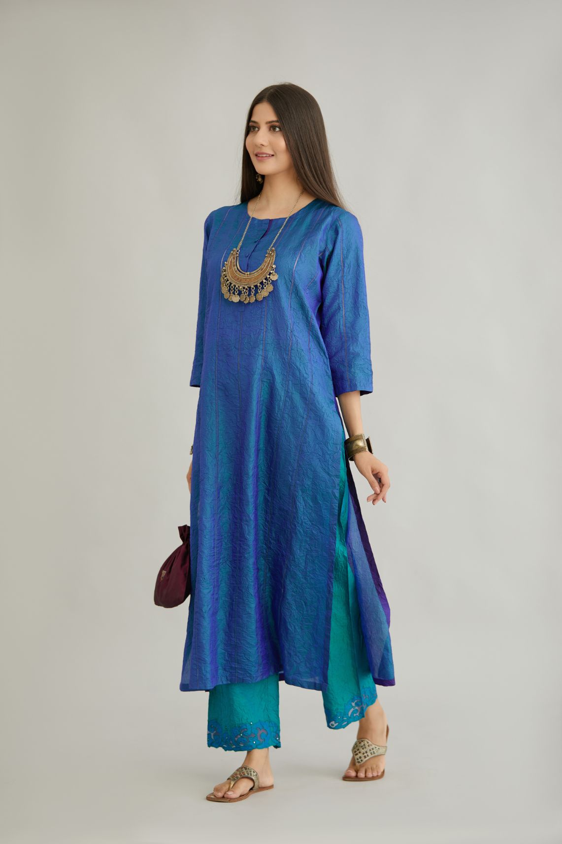 Teal blue hand crushed silk straight kurta set with vertical organza fabric inset stripe detail in front, back and 3/4 sleeves, highlighted with contrasting top stitch.