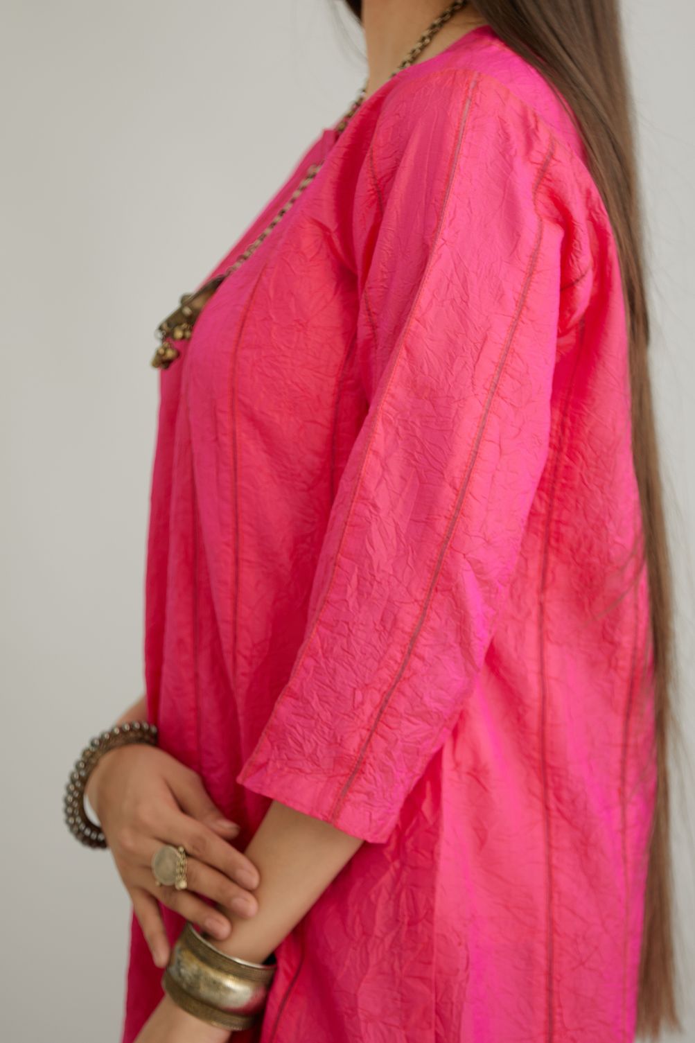 Fuchsia hand crushed silk straight kurta set with vertical organza fabric inset stripe detail in front, back and 3/4 sleeves, highlighted with contrasting top stitch.