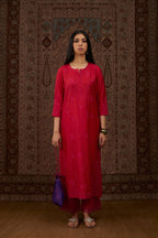Red hand crushed silk kurta set with all-over contrast silk fabric applique work and embroidered button placket neckline.
