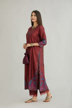 Maroon hand crushed silk kurta set with contrast silk fabric applique work at hem, side slits and sleeves with an embroidered neckline.