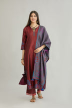 Maroon hand crushed silk kurta set with contrast silk fabric applique work at hem, side slits and sleeves with an embroidered neckline.