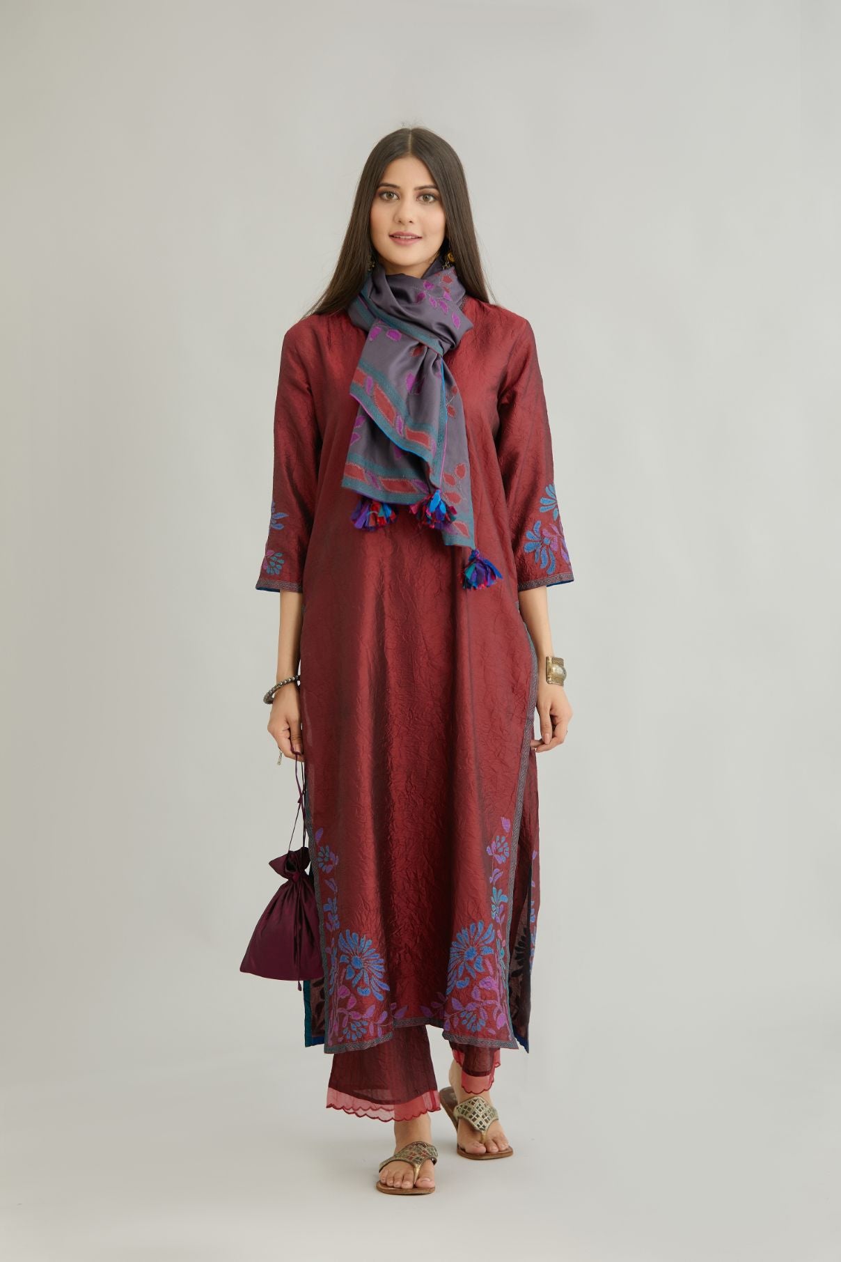 Maroon hand crushed silk kurta set with contrast silk fabric applique work at hem, side slits and sleeves with an embroidered neckline.