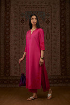 Fuchsia hand crushed silk kurta set with contrast silk fabric applique work at hem, side slits and sleeves with an embroidered neckline.