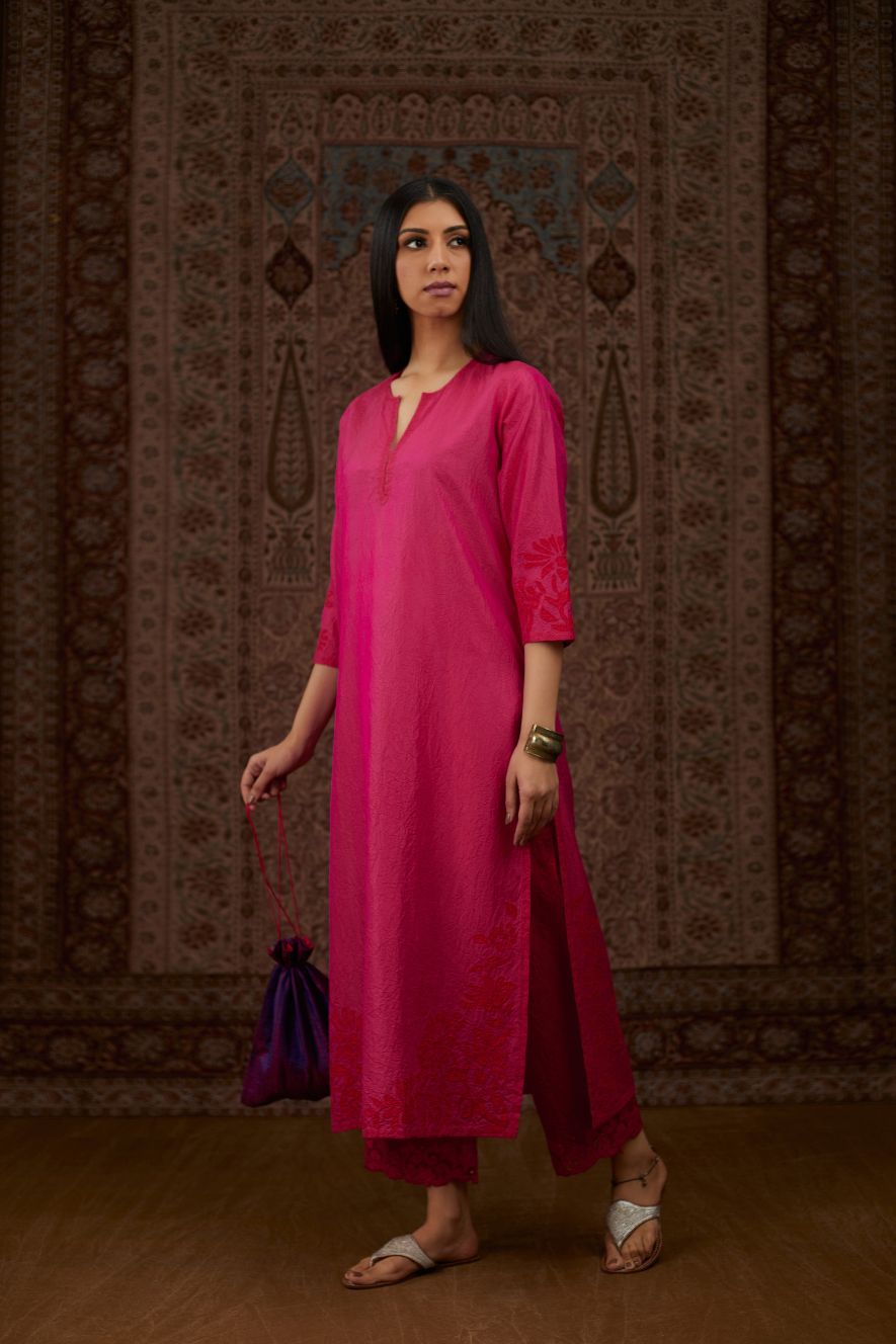 Fuchsia hand crushed silk kurta set with contrast silk fabric applique work at hem, side slits and sleeves with an embroidered neckline.