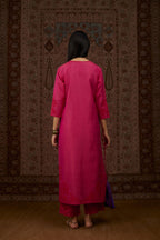 Fuchsia hand crushed silk kurta set with contrast silk fabric applique work at hem, side slits and sleeves with an embroidered neckline.