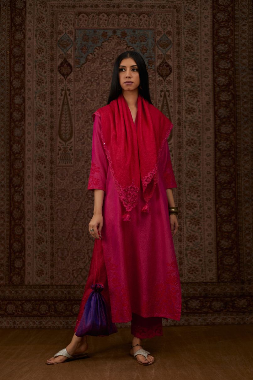 Fuchsia hand crushed silk kurta set with contrast silk fabric applique work at hem, side slits and sleeves with an embroidered neckline.
