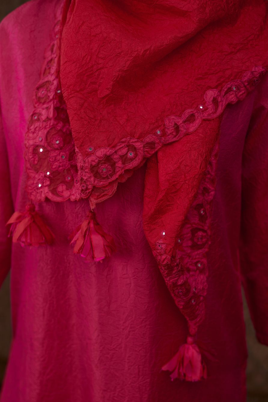 Fuchsia hand crushed silk kurta set with contrast silk fabric applique work at hem, side slits and sleeves with an embroidered neckline.