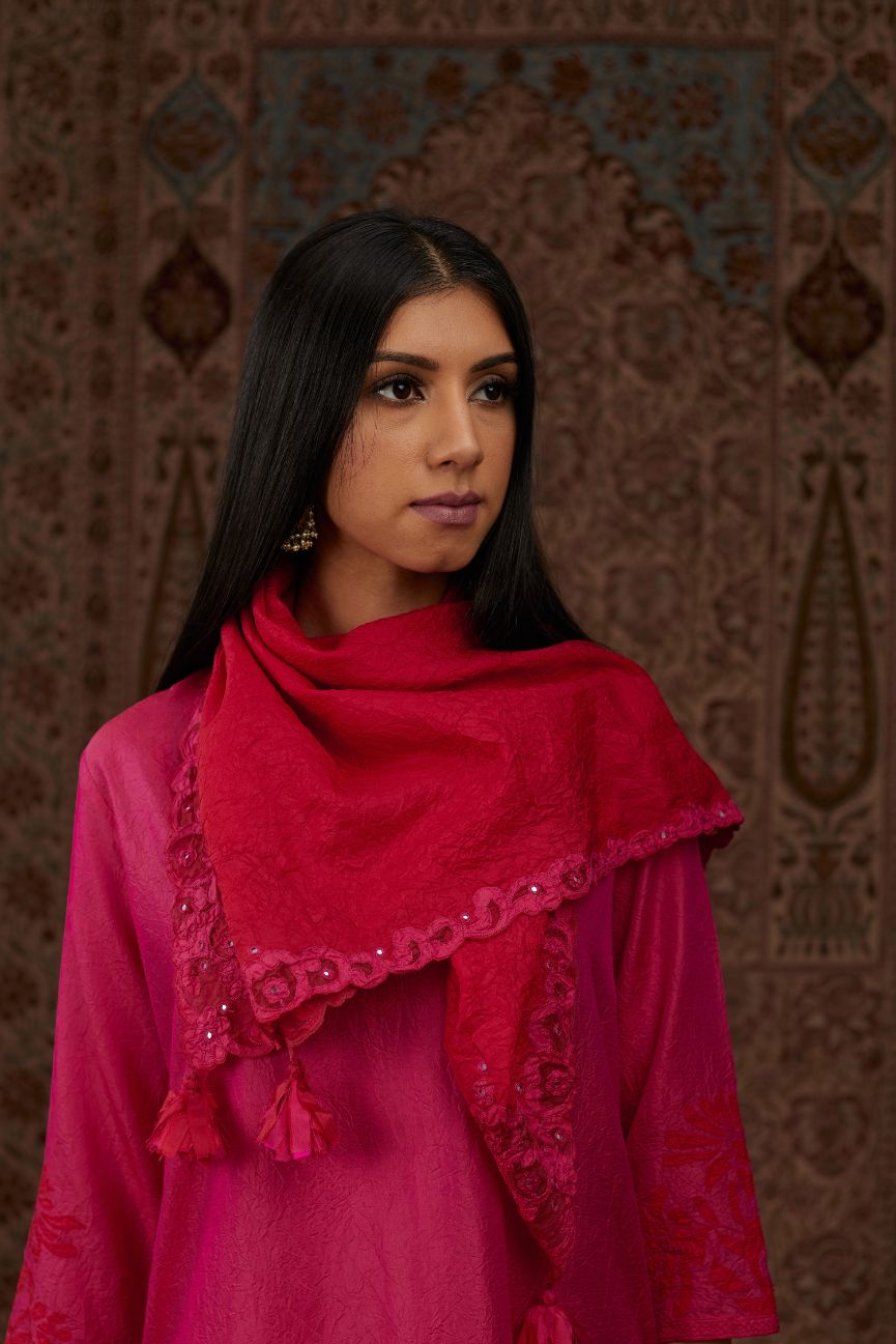 Fuchsia hand crushed silk kurta set with contrast silk fabric applique work at hem, side slits and sleeves with an embroidered neckline.