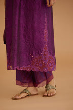 Purple hand crushed silk straight kurta set with silk and organza cutwork embroidery, highlighted with hand attached mirrors.