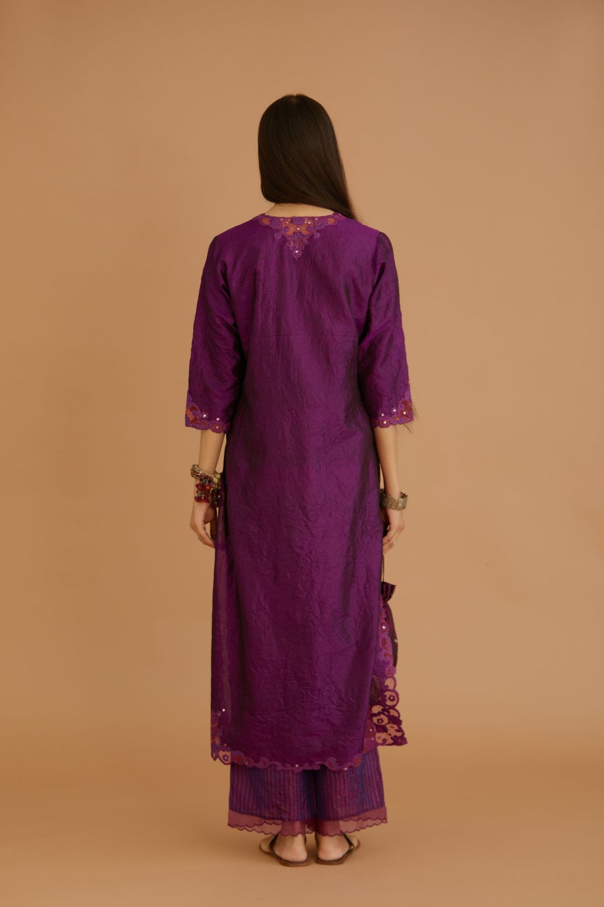 Purple hand crushed silk straight kurta set with silk and organza cutwork embroidery, highlighted with hand attached mirrors.