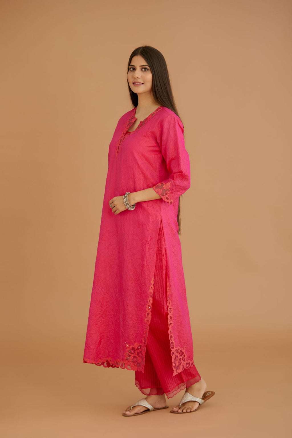 Fuchsia hand crushed silk straight kurta set with silk and organza cutwork embroidery, highlighted with hand attached mirrors.