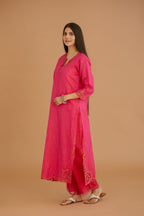 Fuchsia hand crushed silk straight kurta set with silk and organza cutwork embroidery, highlighted with hand attached mirrors.