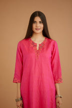 Fuchsia hand crushed silk straight kurta set with silk and organza cutwork embroidery, highlighted with hand attached mirrors.