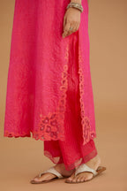 Fuchsia hand crushed silk straight kurta set with silk and organza cutwork embroidery, highlighted with hand attached mirrors.