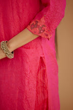 Fuchsia hand crushed silk straight kurta set with silk and organza cutwork embroidery, highlighted with hand attached mirrors.