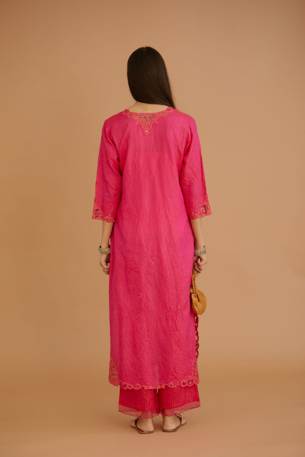 Fuchsia hand crushed silk straight kurta set with silk and organza cutwork embroidery, highlighted with hand attached mirrors.