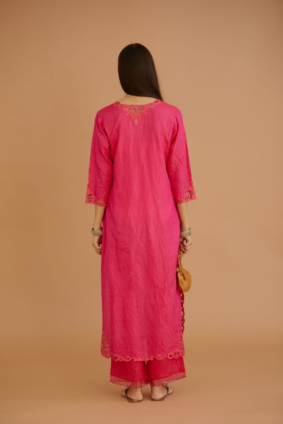 Fuchsia hand crushed silk straight kurta set with silk and organza cutwork embroidery, highlighted with hand attached mirrors.