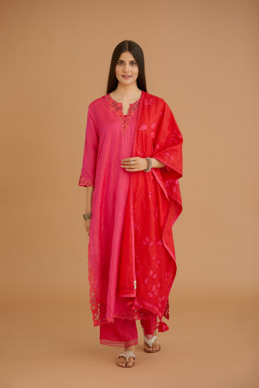 Fuchsia hand crushed silk straight kurta set with silk and organza cutwork embroidery, highlighted with hand attached mirrors.