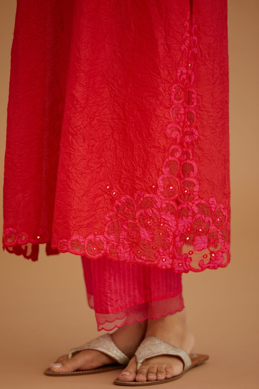 Red hand crushed silk straight kurta set with silk and organza cutwork embroidery, highlighted with hand attached mirrors.