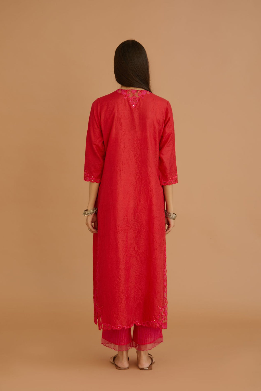 Red hand crushed silk straight kurta set with silk and organza cutwork embroidery, highlighted with hand attached mirrors.