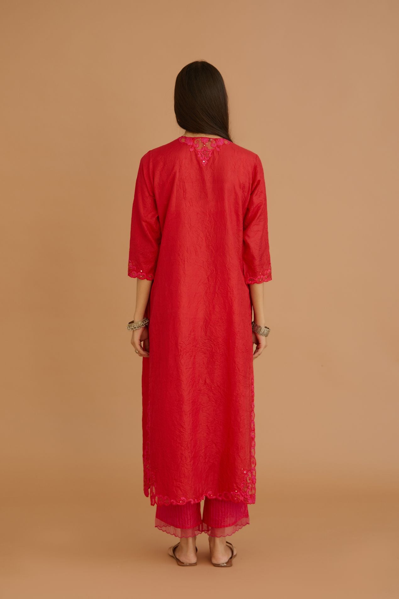 Red hand crushed silk straight kurta set with silk and organza cutwork embroidery, highlighted with hand attached mirrors.