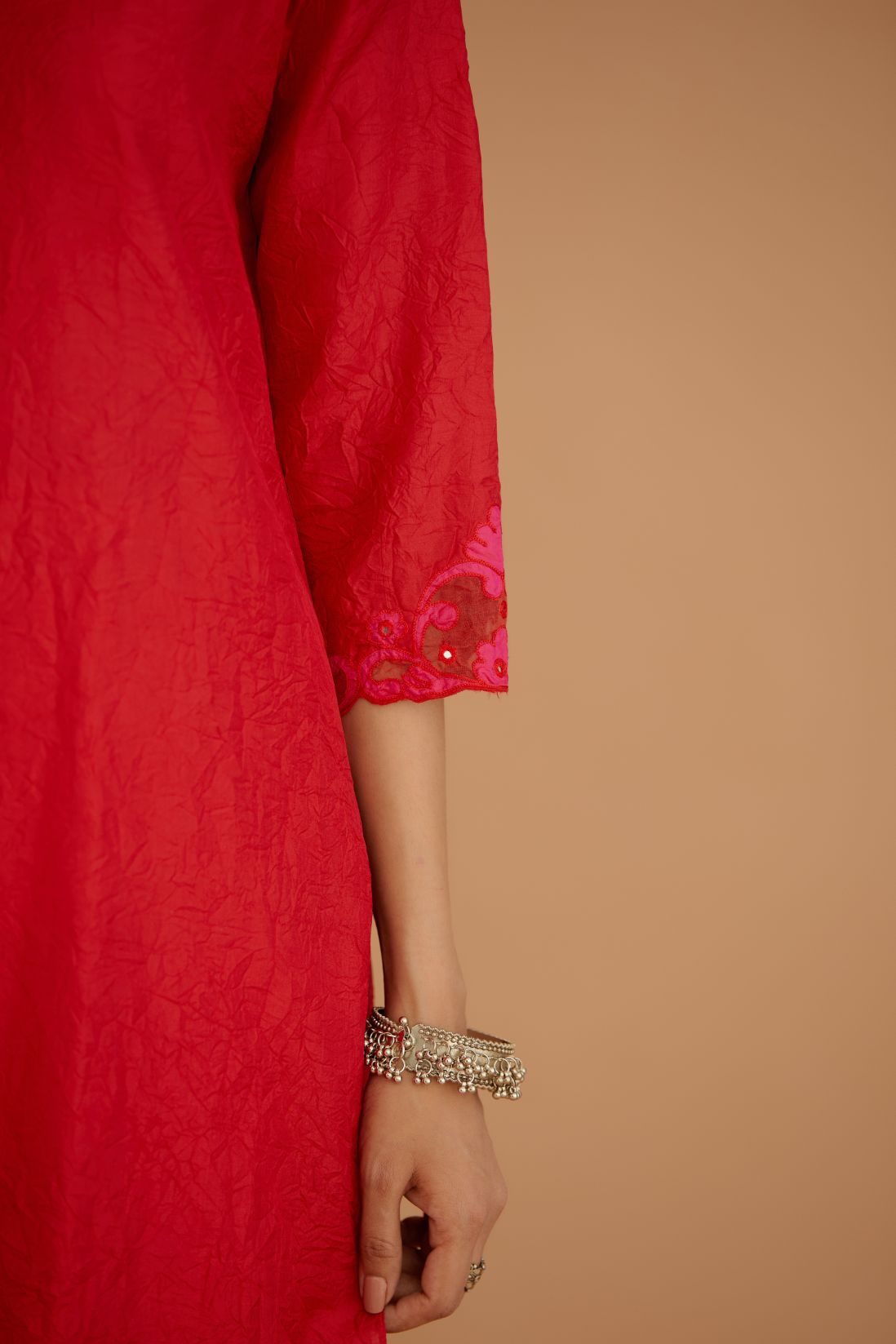 Red hand crushed silk straight kurta set with silk and organza cutwork embroidery, highlighted with hand attached mirrors.
