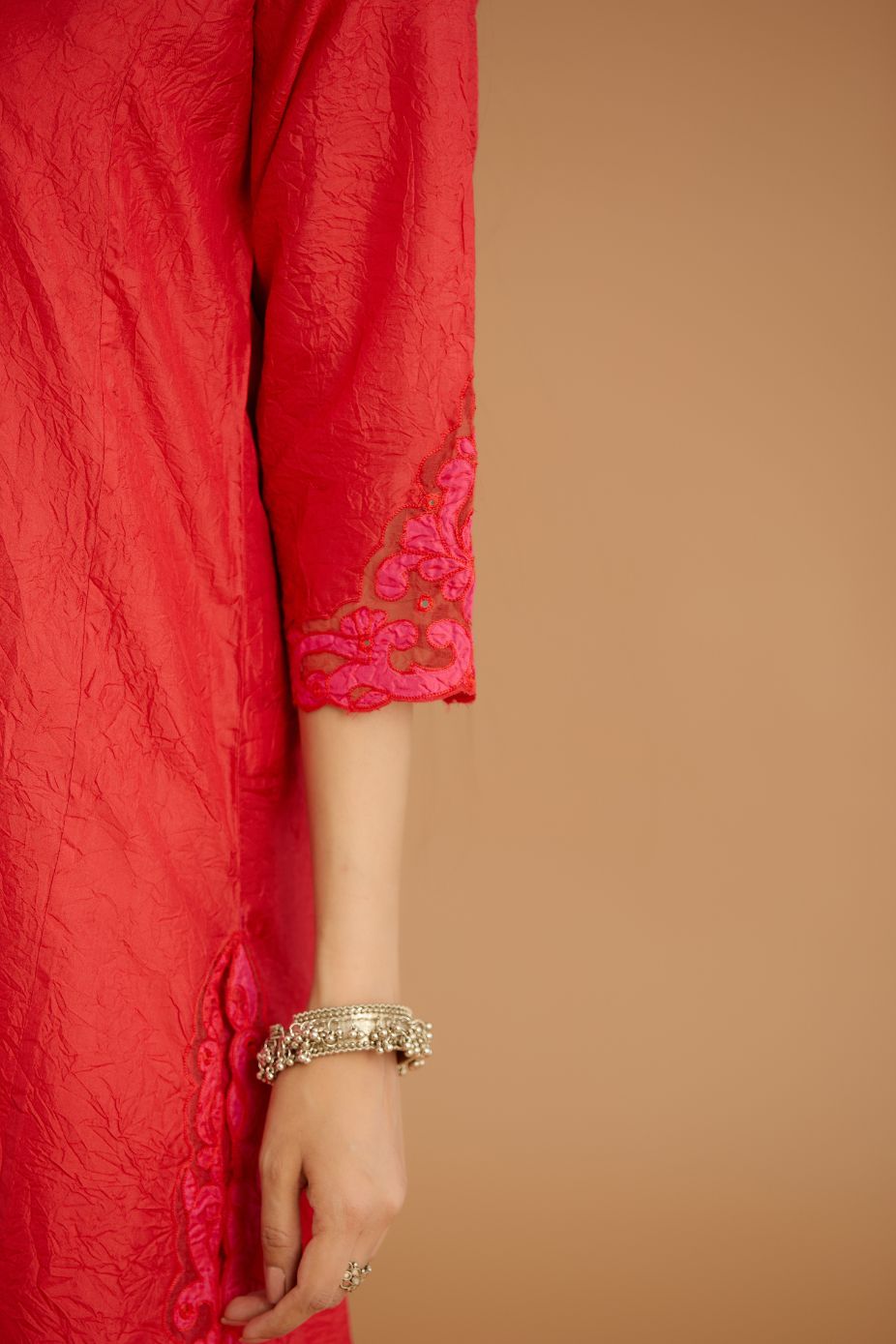 Red hand crushed silk straight kurta set with silk and organza cutwork embroidery, highlighted with hand attached mirrors.