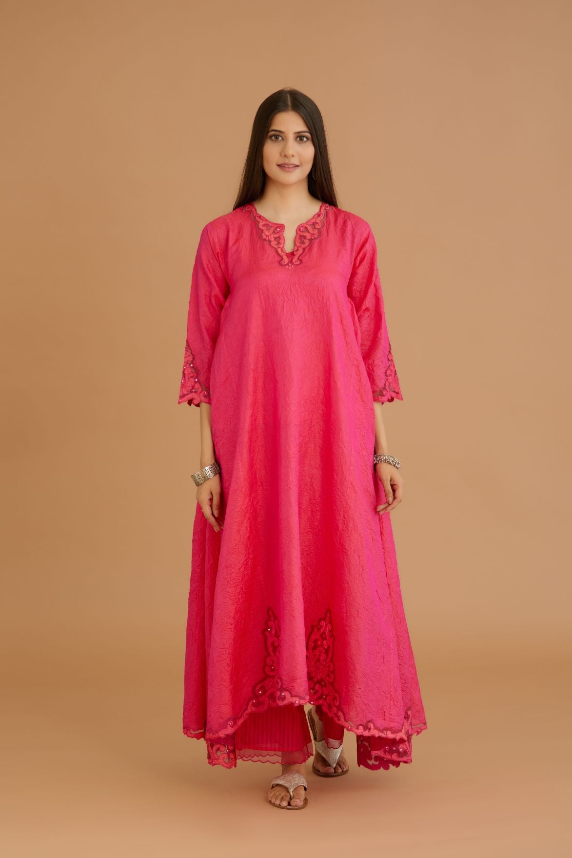 Fuchsia hand crushed silk kurta set with cutwork embroidered asymmetric hem, highlighted with hand attached mirrors.