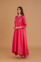 Fuchsia hand crushed silk kurta set with cutwork embroidered asymmetric hem, highlighted with hand attached mirrors.