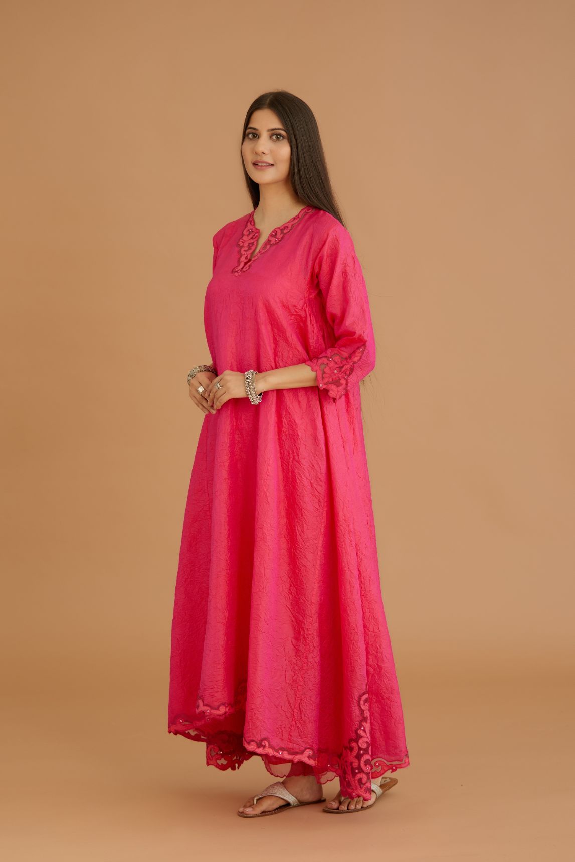 Fuchsia hand crushed silk kurta set with cutwork embroidered asymmetric hem, highlighted with hand attached mirrors.