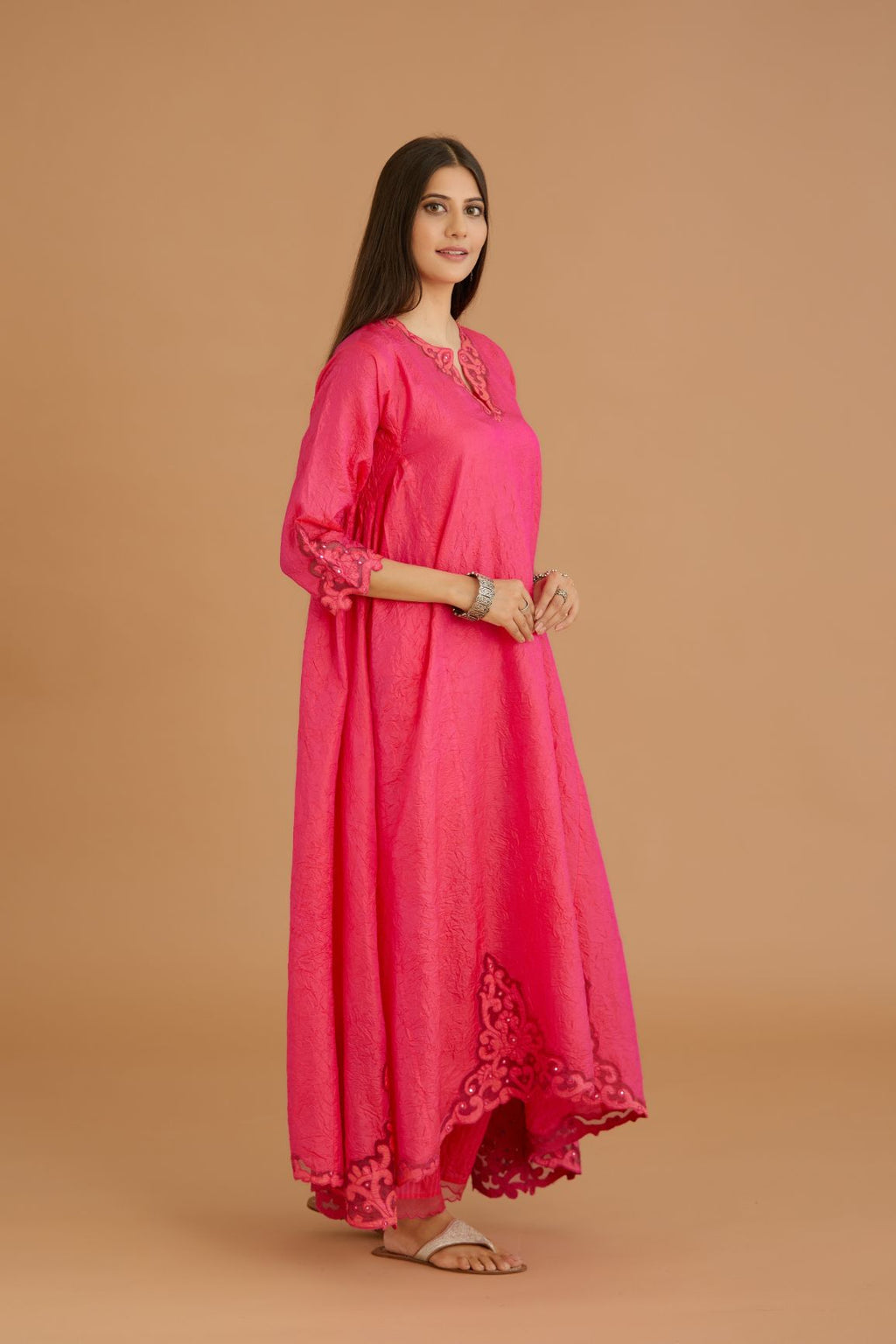 Fuchsia hand crushed silk kurta set with cutwork embroidered asymmetric hem, highlighted with hand attached mirrors.