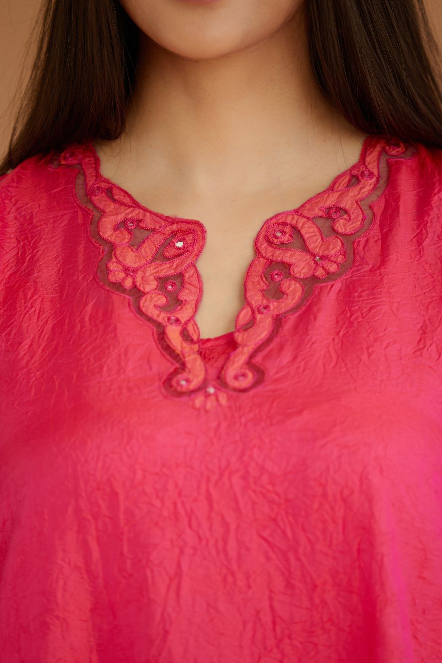 Fuchsia hand crushed silk kurta set with cutwork embroidered asymmetric hem, highlighted with hand attached mirrors.