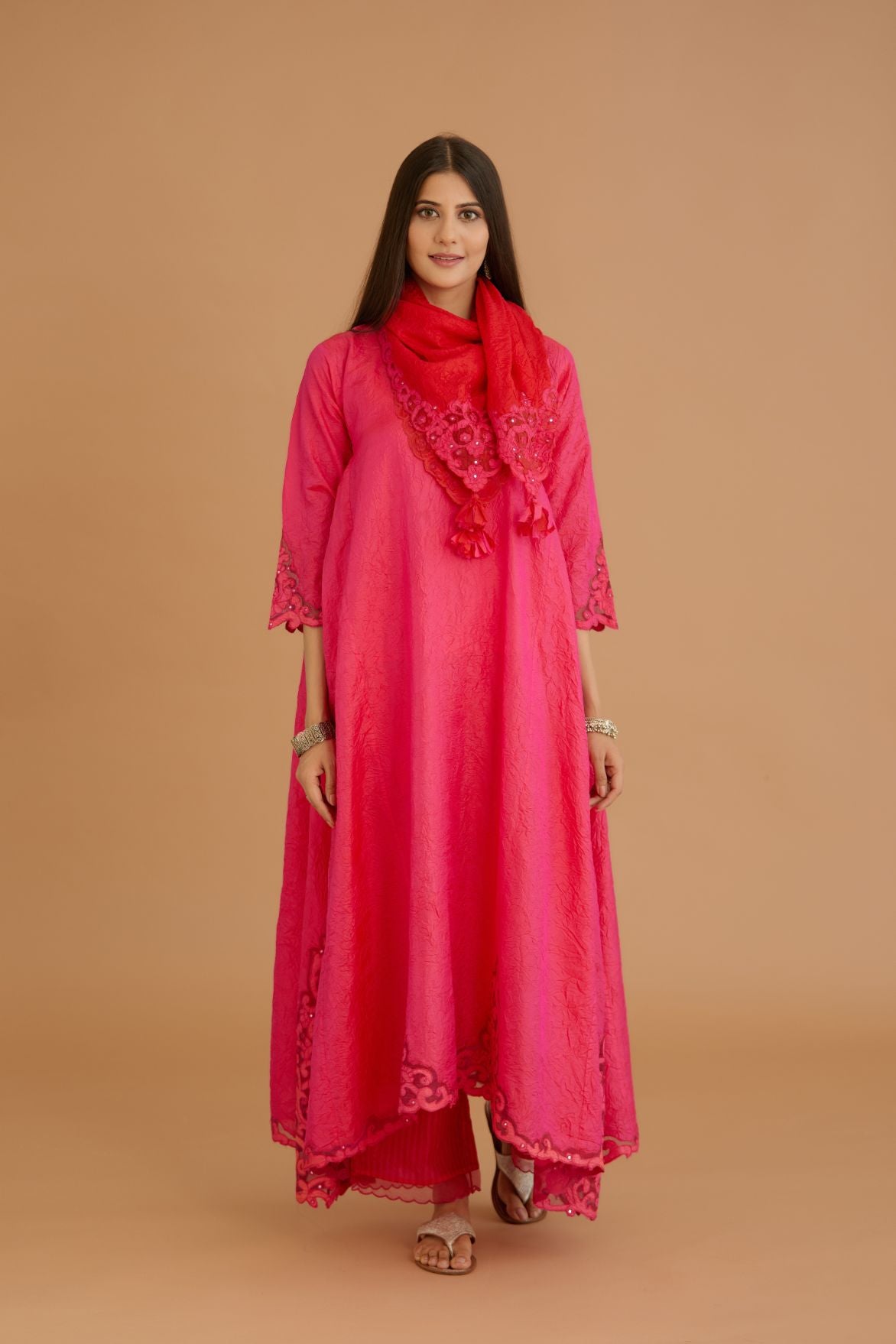 Fuchsia hand crushed silk kurta set with cutwork embroidered asymmetric hem, highlighted with hand attached mirrors.