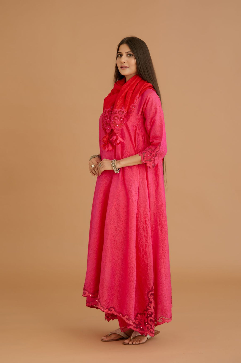 Fuchsia hand crushed silk kurta set with cutwork embroidered asymmetric hem, highlighted with hand attached mirrors.