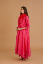 Fuchsia hand crushed silk kurta set with cutwork embroidered asymmetric hem, highlighted with hand attached mirrors.