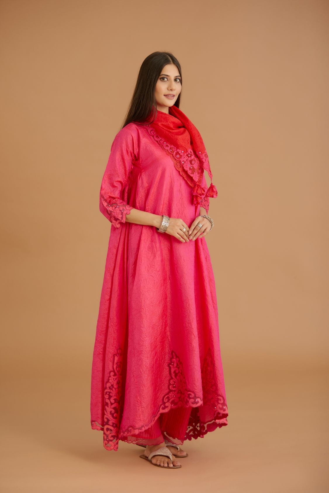 Fuchsia hand crushed silk kurta set with cutwork embroidered asymmetric hem, highlighted with hand attached mirrors.