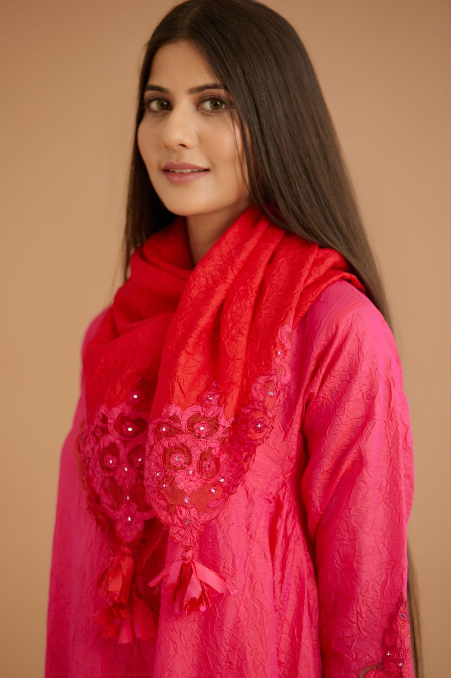 Fuchsia hand crushed silk kurta set with cutwork embroidered asymmetric hem, highlighted with hand attached mirrors.