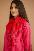 Fuchsia hand crushed silk kurta set with cutwork embroidered asymmetric hem, highlighted with hand attached mirrors.