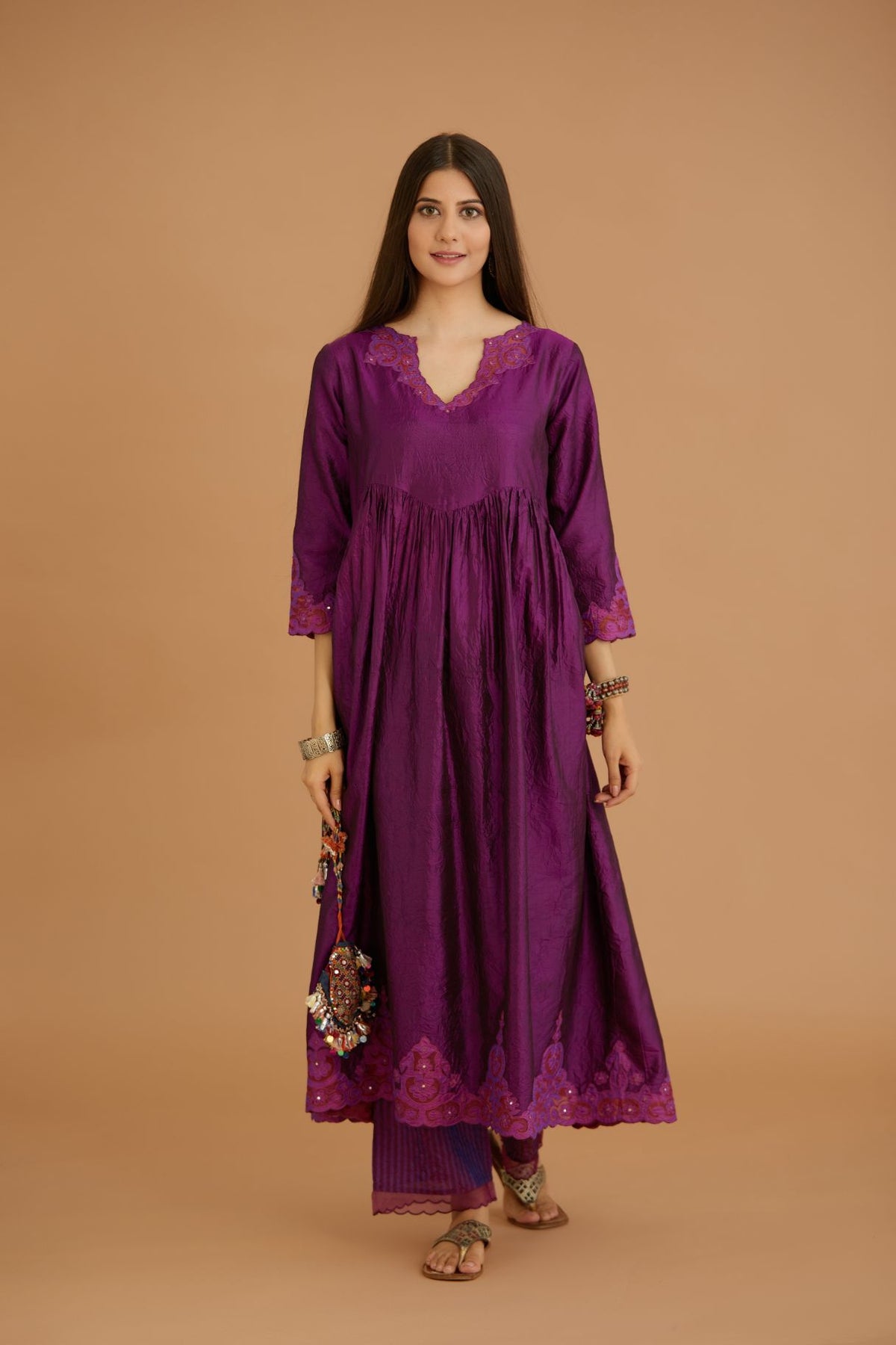 Purple hand crushed silk kurta set with wavy empire waistline and gathers, with silk and organza cutwork embroidery, highlighted with hand attached mirrors.