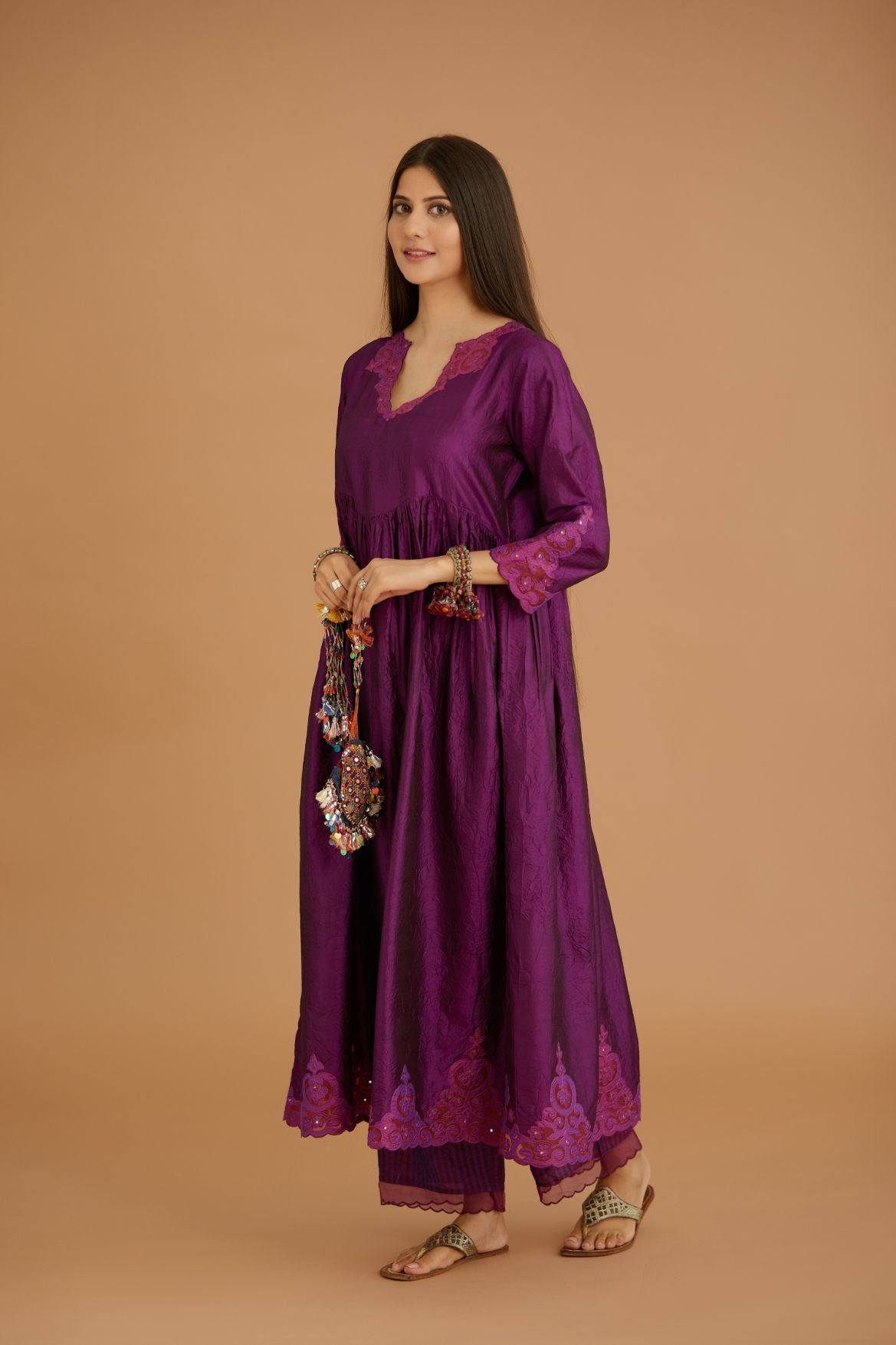 Purple hand crushed silk kurta set with wavy empire waistline and gathers, with silk and organza cutwork embroidery, highlighted with hand attached mirrors.