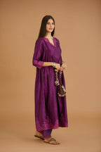 Purple hand crushed silk kurta set with wavy empire waistline and gathers, with silk and organza cutwork embroidery, highlighted with hand attached mirrors.
