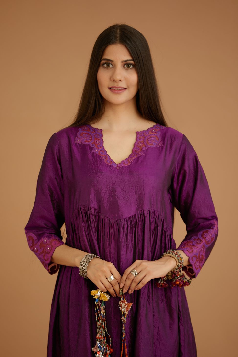 Purple hand crushed silk kurta set with wavy empire waistline and gathers, with silk and organza cutwork embroidery, highlighted with hand attached mirrors.