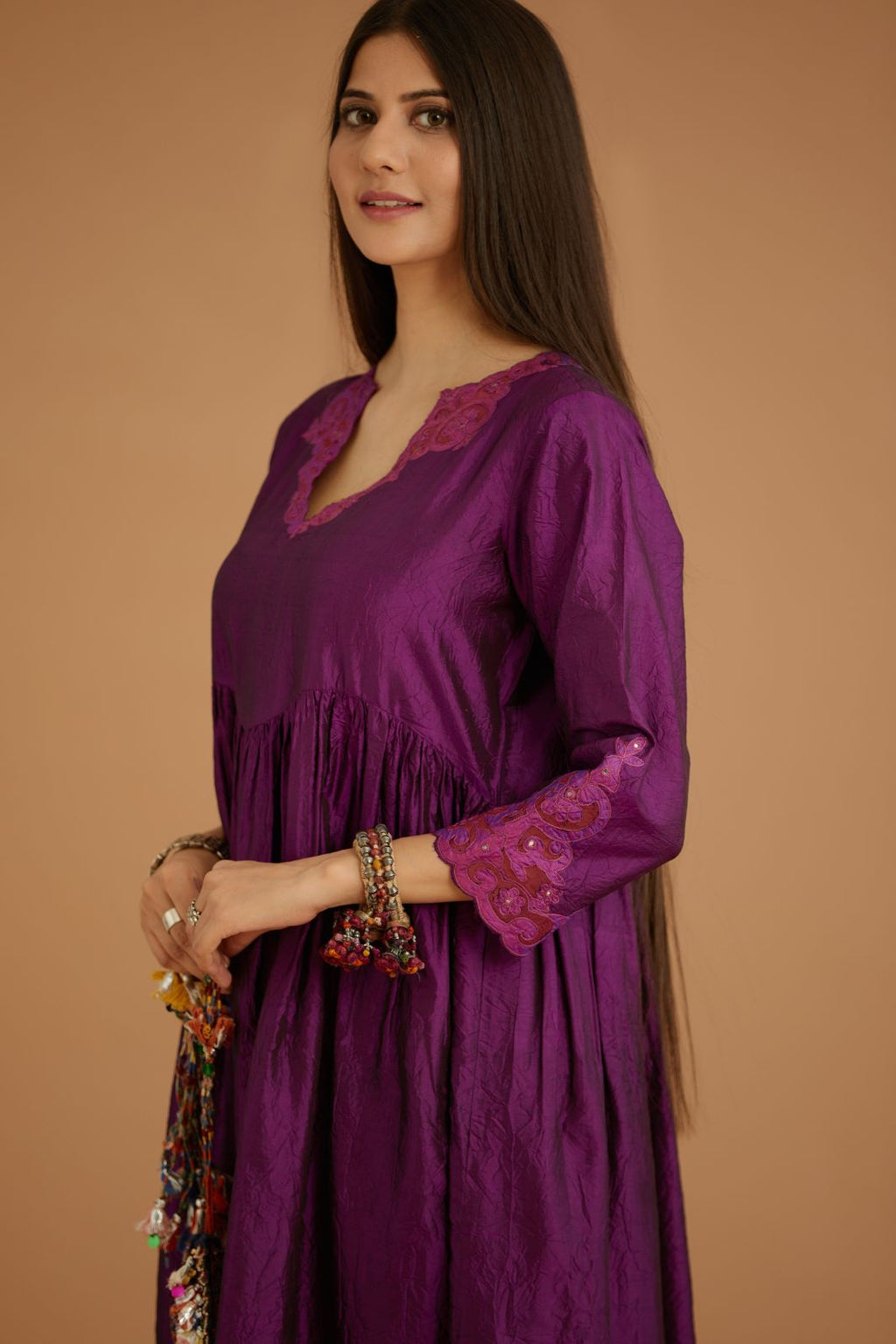 Purple hand crushed silk kurta set with wavy empire waistline and gathers, with silk and organza cutwork embroidery, highlighted with hand attached mirrors.