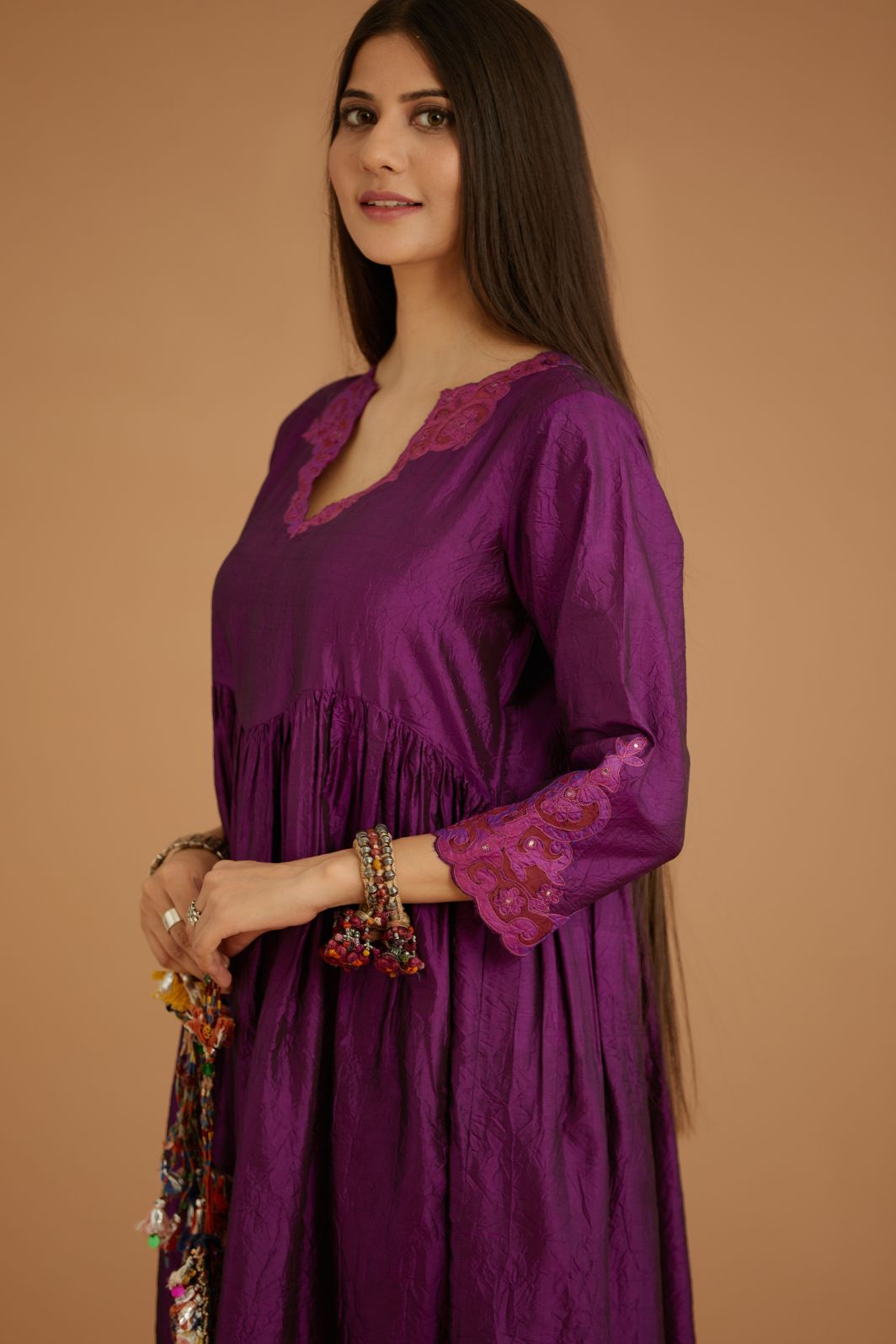 Purple hand crushed silk kurta set with wavy empire waistline and gathers, with silk and organza cutwork embroidery, highlighted with hand attached mirrors.