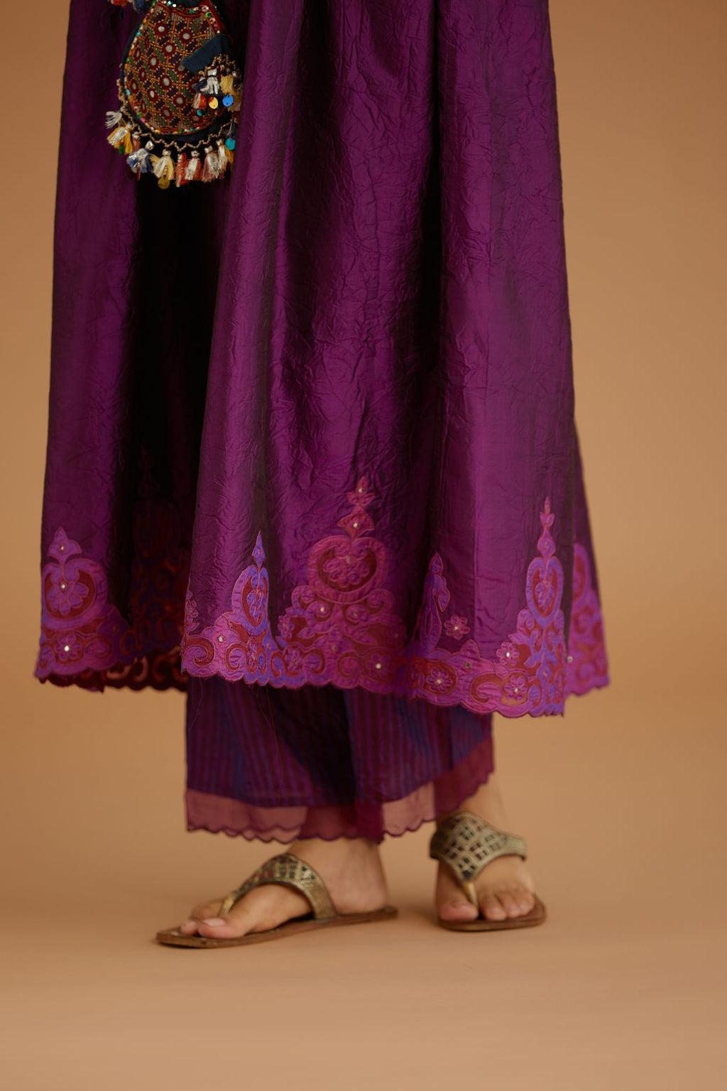 Purple hand crushed silk kurta set with wavy empire waistline and gathers, with silk and organza cutwork embroidery, highlighted with hand attached mirrors.