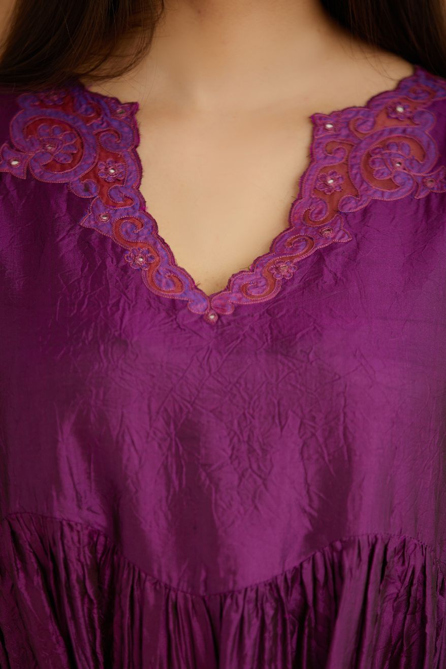 Purple hand crushed silk kurta set with wavy empire waistline and gathers, with silk and organza cutwork embroidery, highlighted with hand attached mirrors.