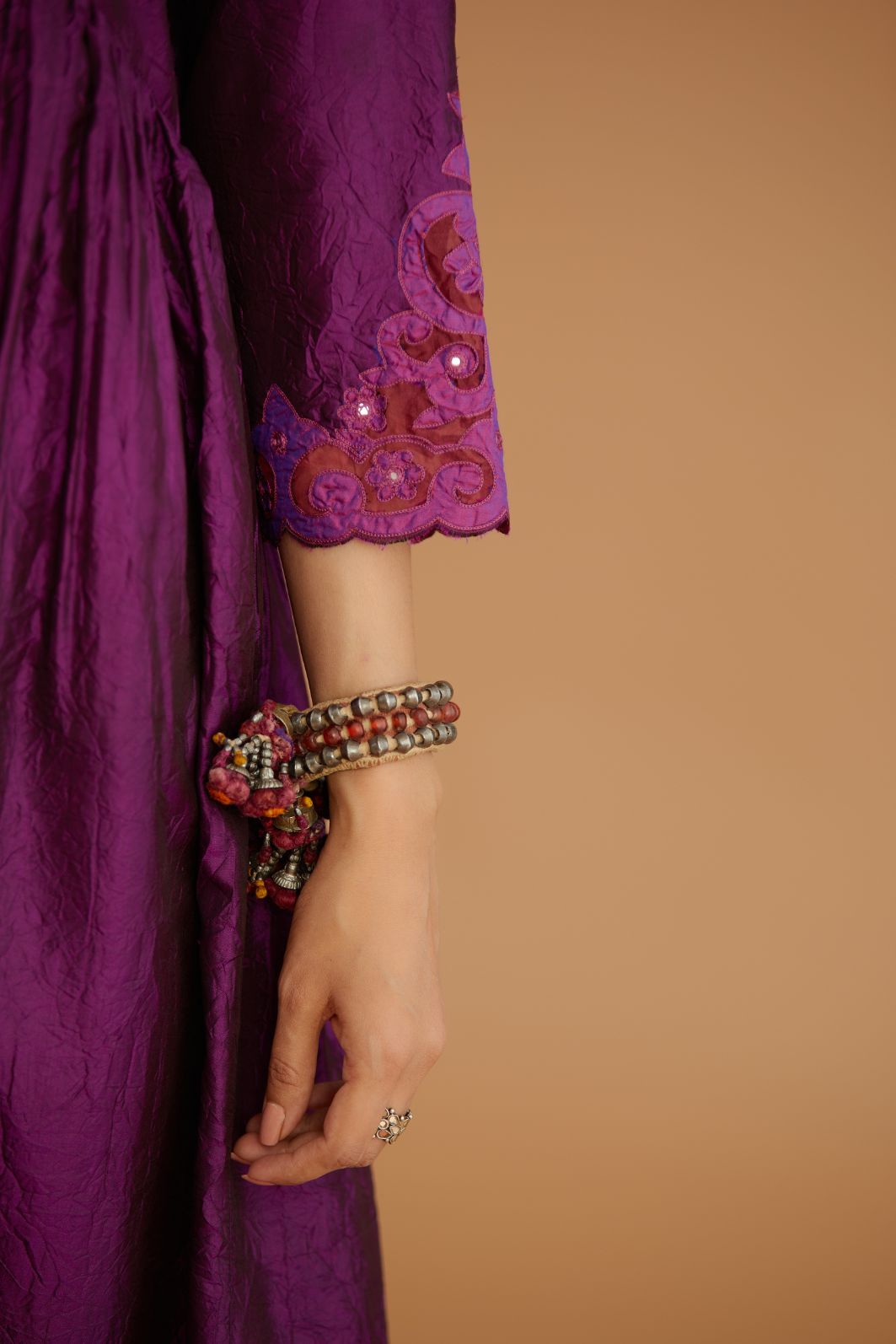 Purple hand crushed silk kurta set with wavy empire waistline and gathers, with silk and organza cutwork embroidery, highlighted with hand attached mirrors.