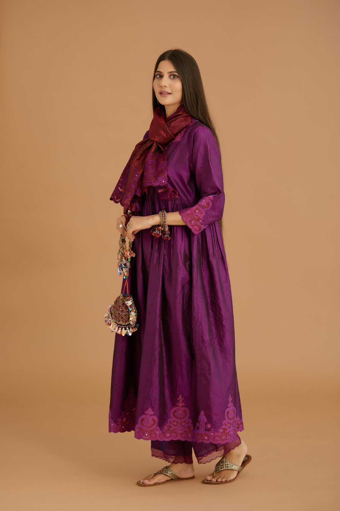 Purple hand crushed silk kurta set with wavy empire waistline and gathers, with silk and organza cutwork embroidery, highlighted with hand attached mirrors.