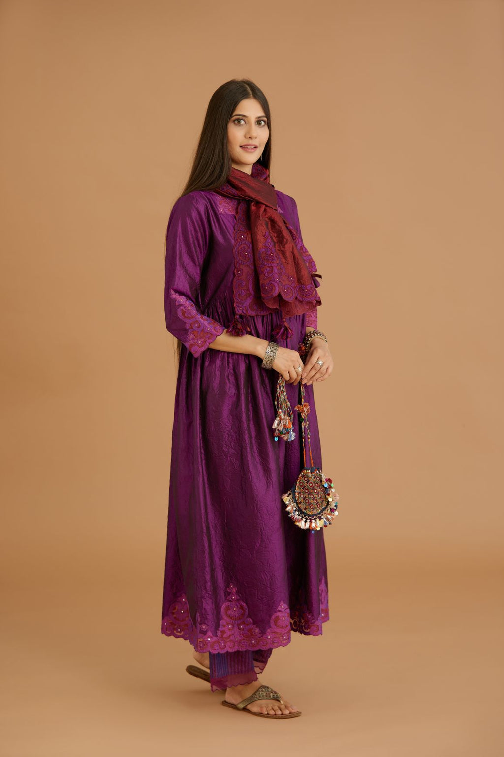 Purple hand crushed silk kurta set with wavy empire waistline and gathers, with silk and organza cutwork embroidery, highlighted with hand attached mirrors.